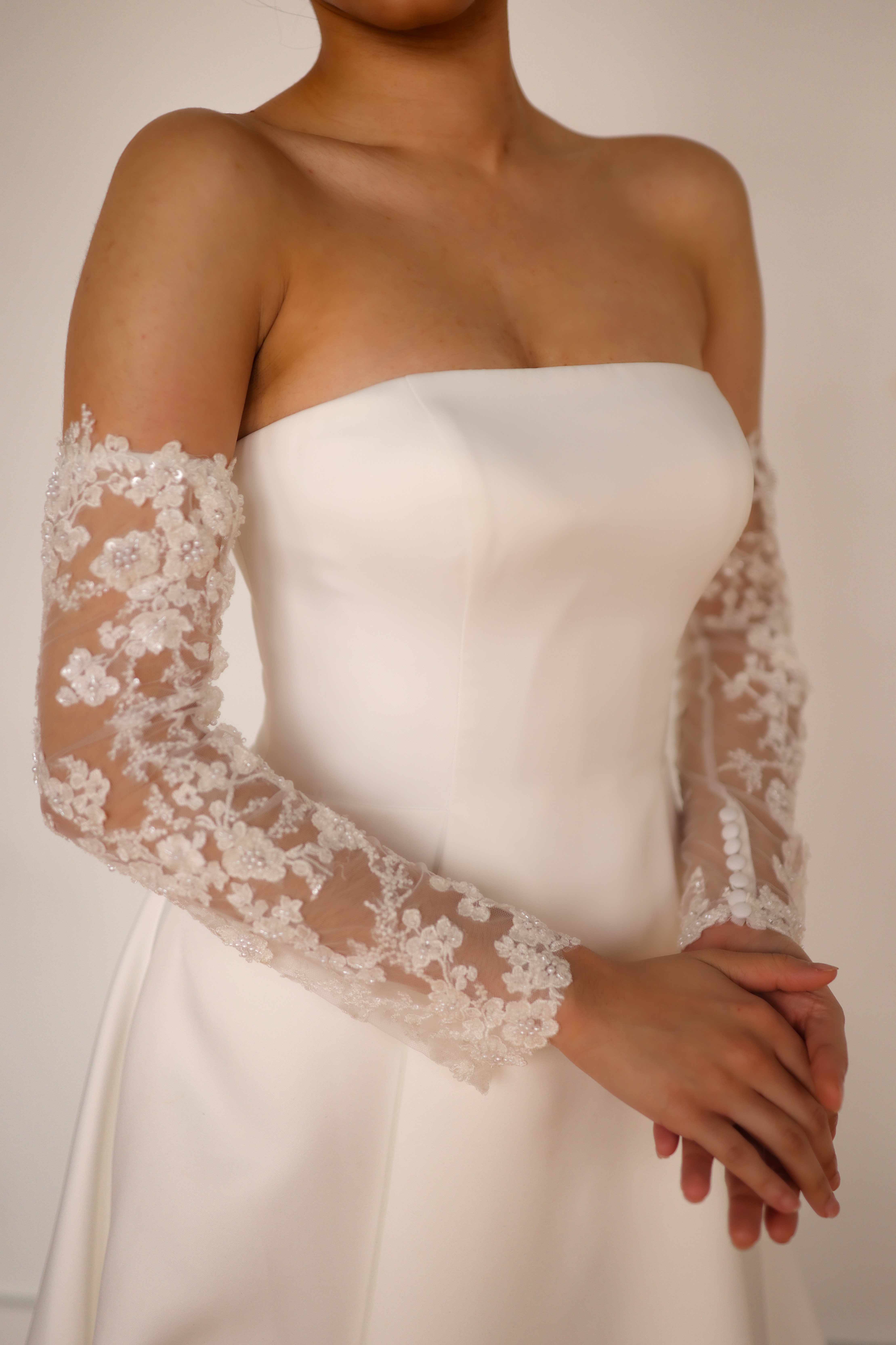 Bride happily looking at wedding dresses on a laptop at home