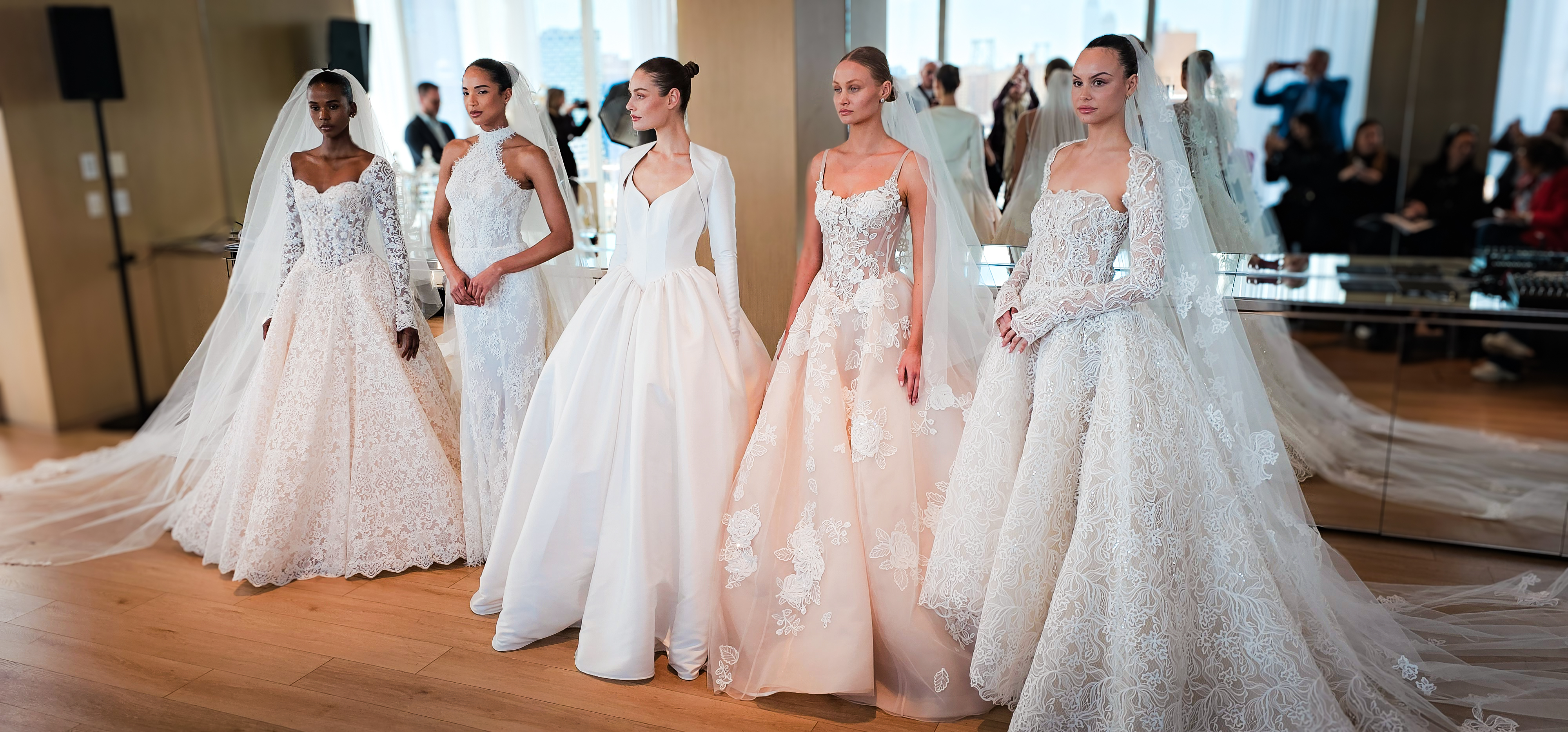 Models line up in their couture bridal looks at the Nicole + Felicia Fashion Show for their Spring/Summer 2027 collection at New York Bridal Fashion Week. 